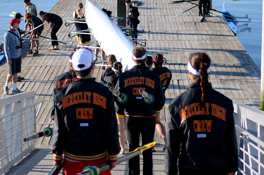 Rowers carrying boat down a gangway